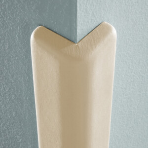Corner guard protecting blue wall edge.