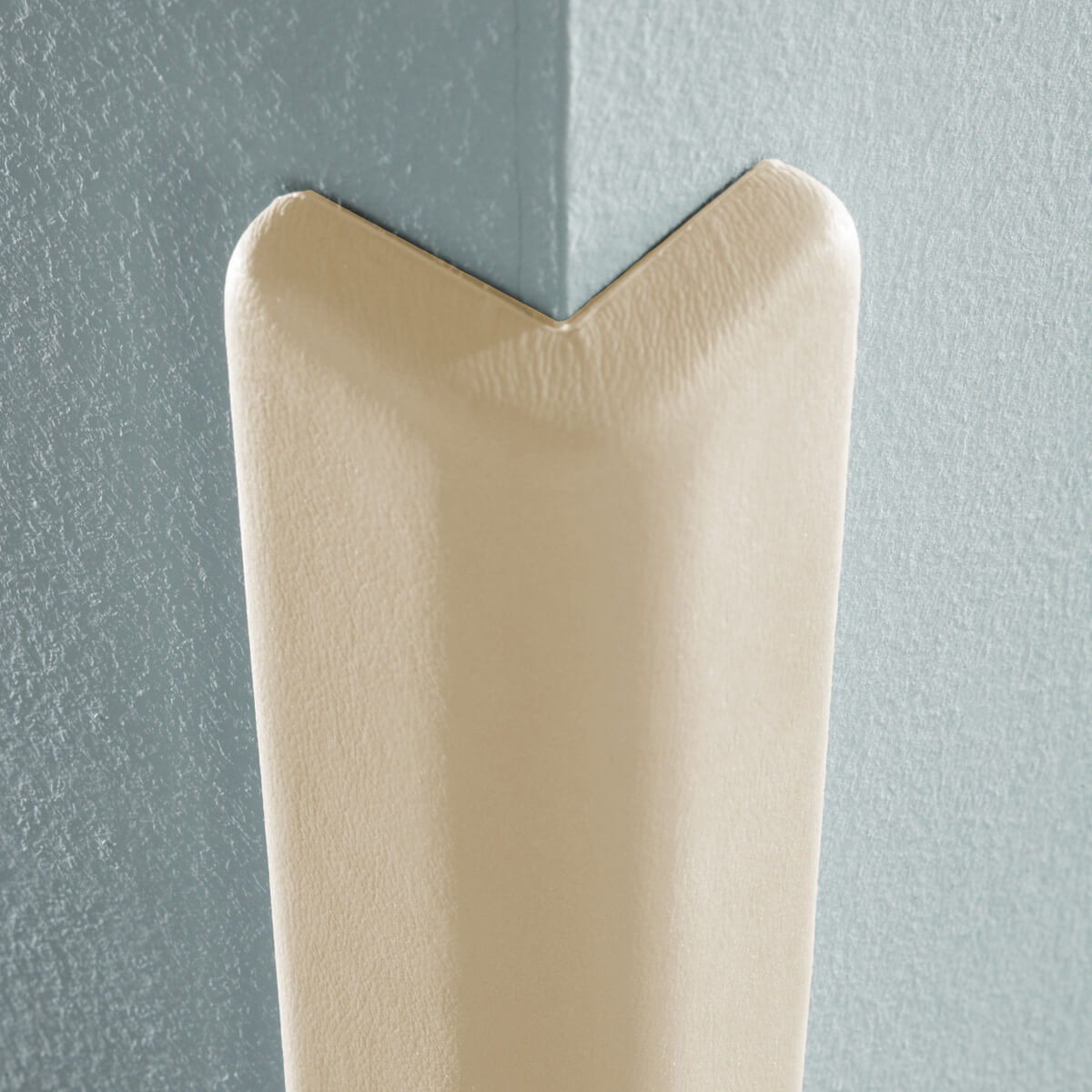 Corner guard protecting blue wall edge.