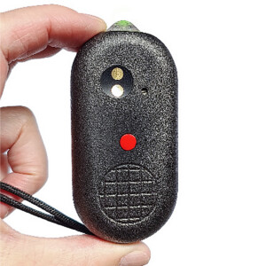 Hand holding black remote with red button.