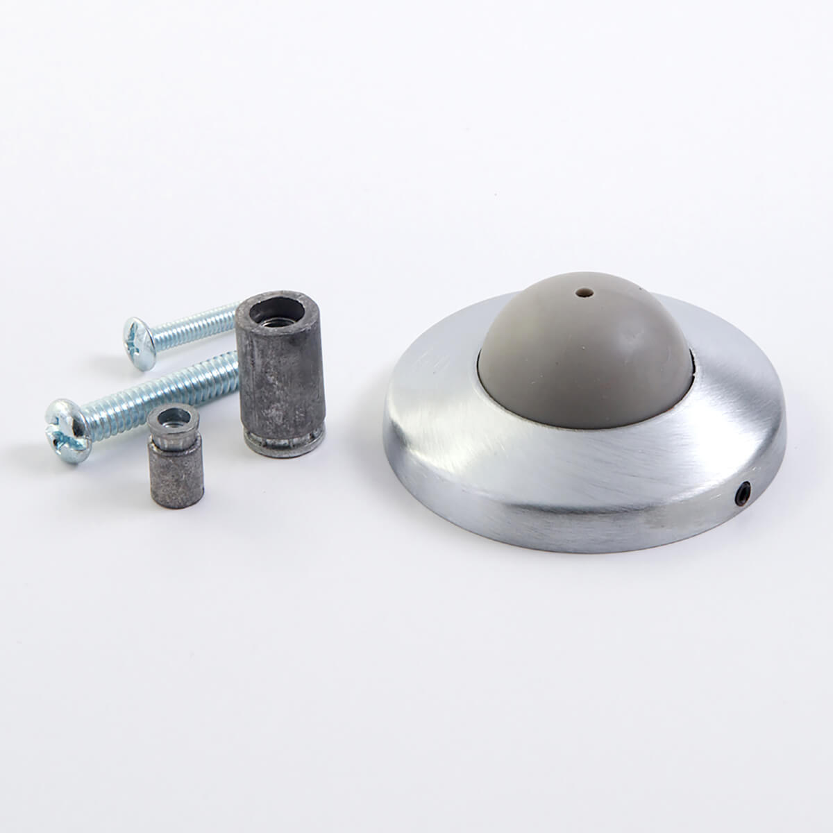 Metal door stopper with screws and anchors displayed.
